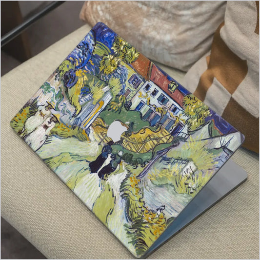 Van Gogh Street in Saintes-Maries MacBook skin with colourful village artwork in soft blue and yellow tones